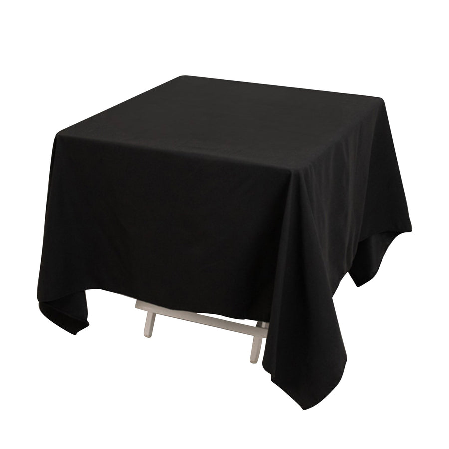 Black tablecloth draped over a table in a studio-style shot.