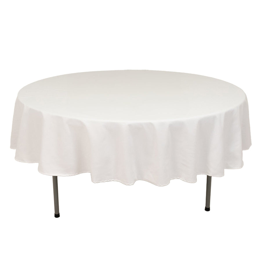 Round white table with a smooth tablecloth, showcasing its full shape.