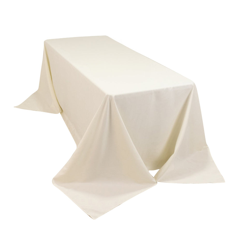 White rectangular table with draped tablecloth