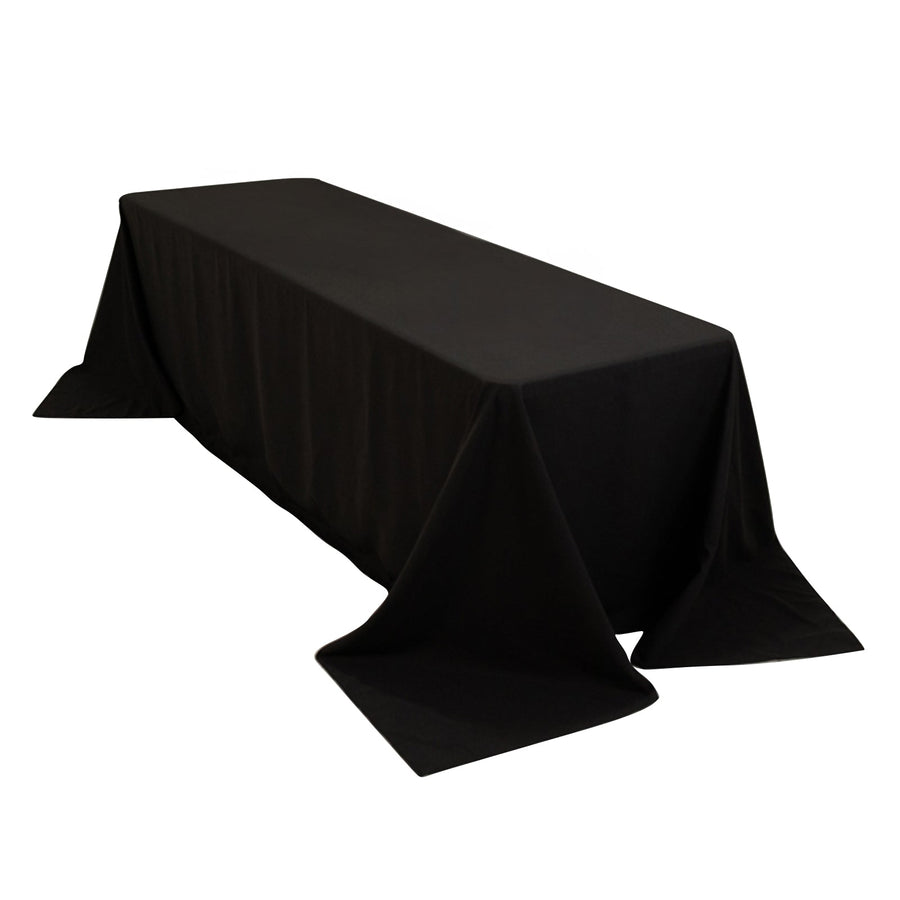 Black tablecloth draped over a long table on a white background.