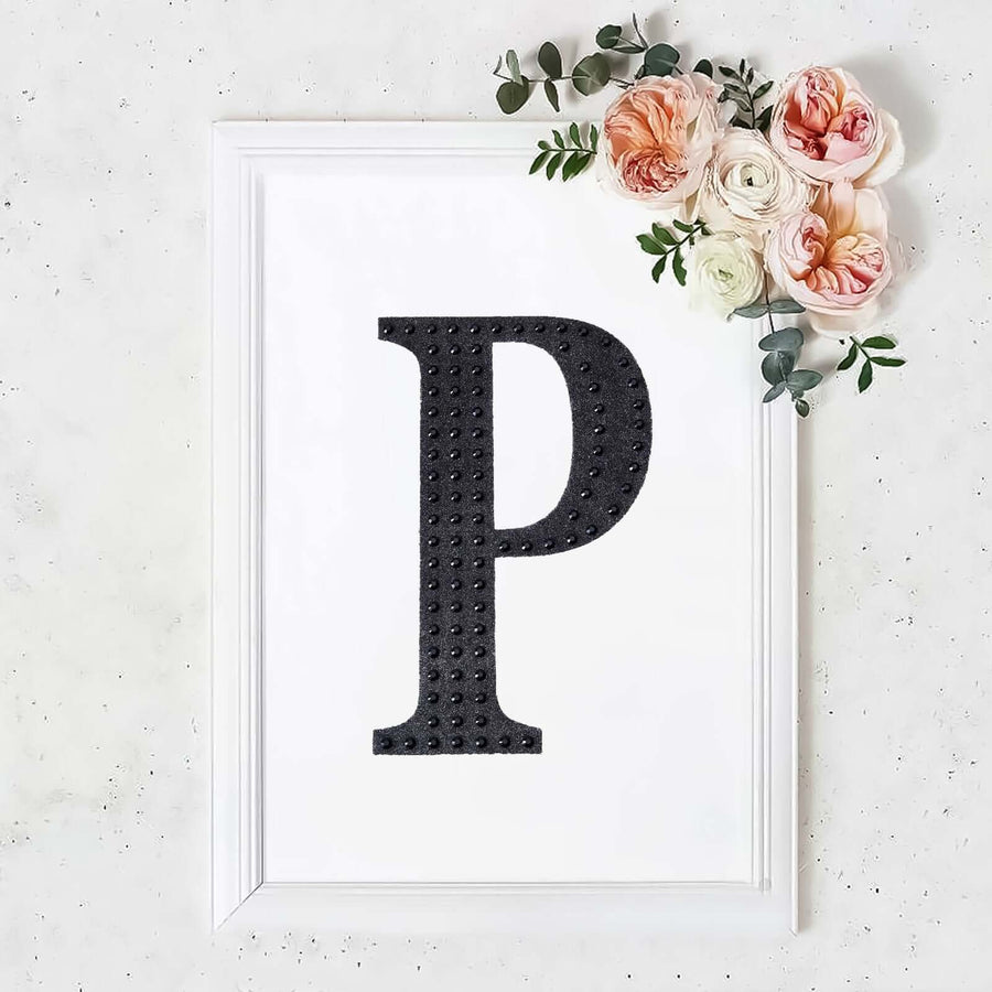 Black letter "P" framed art print with floral accents.