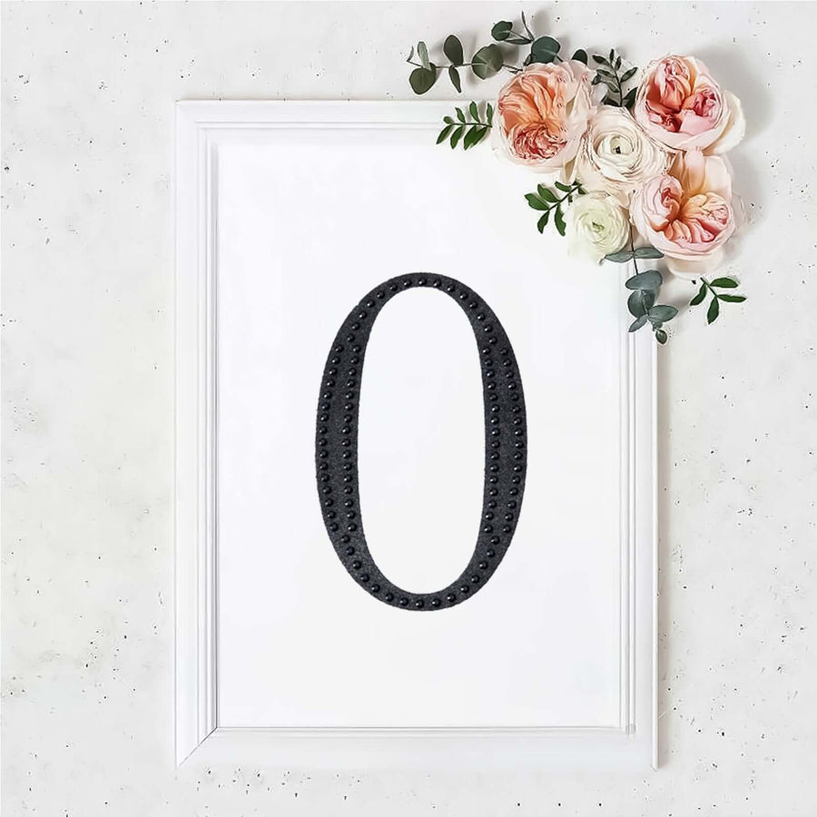 Framed black number zero with flowers on a white background