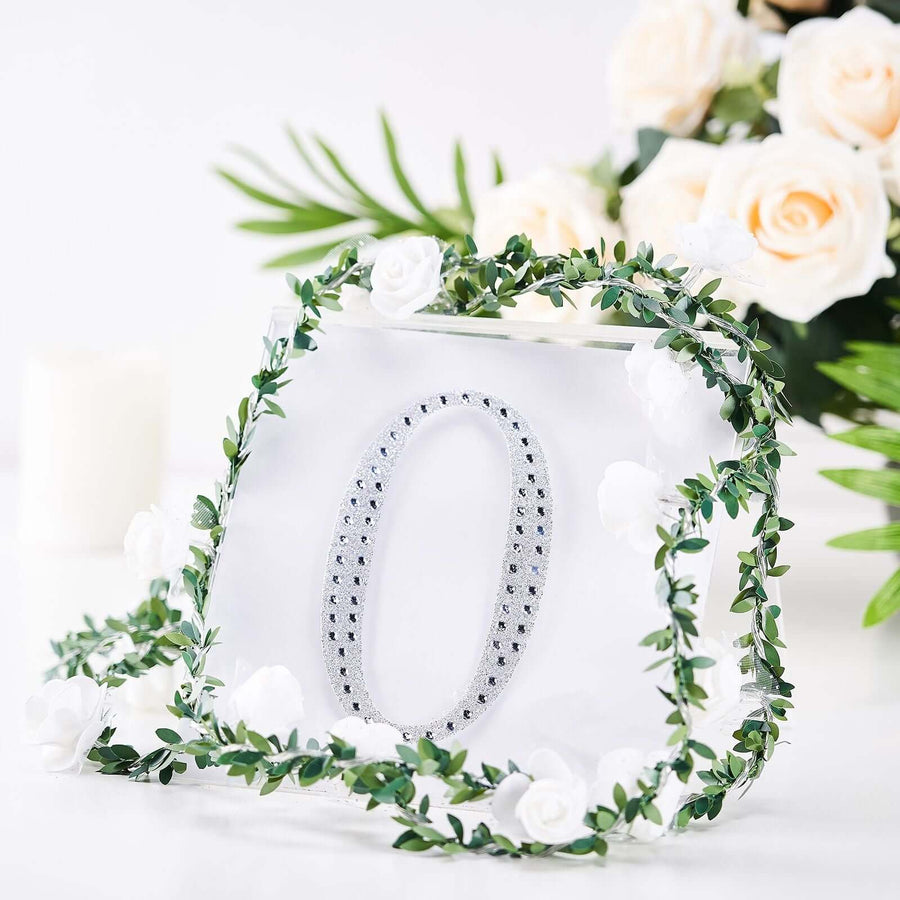 Decorative number "0" adorned with flowers and greenery