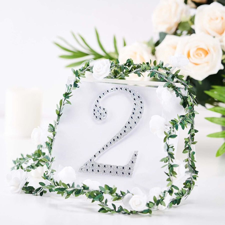 Elegant table number 2 with floral accents on a clear base.