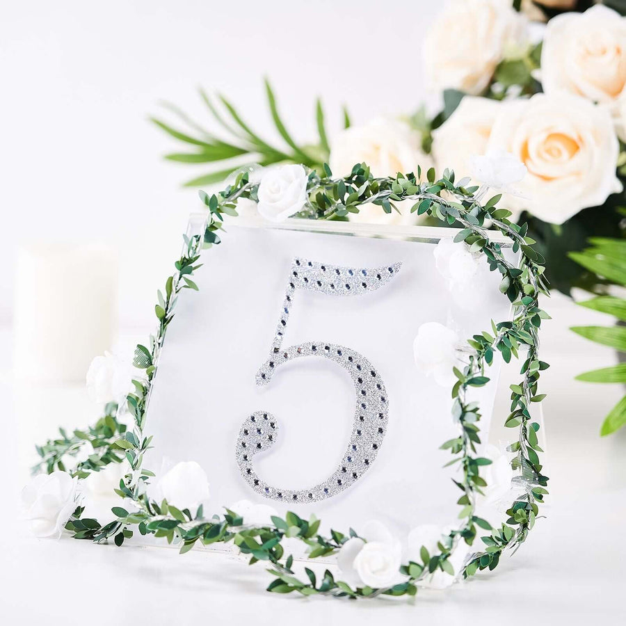 Table number five with silver rhinestones and floral decorations.