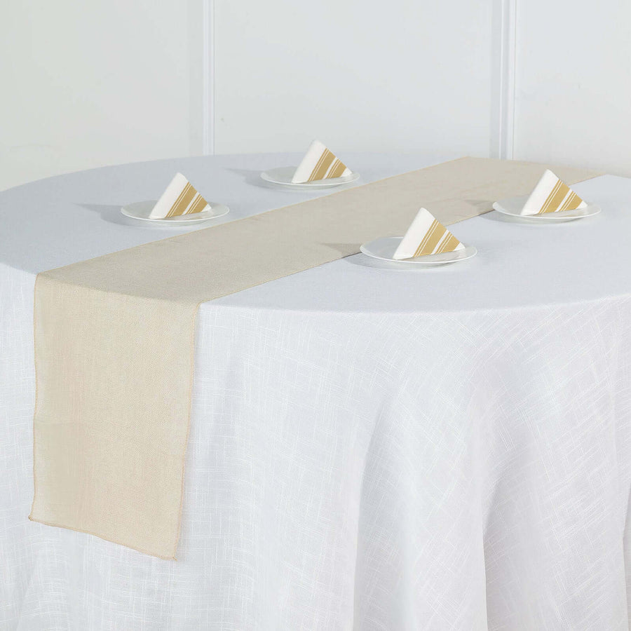 Beige table runner on a white table with plates and napkins arranged neatly.