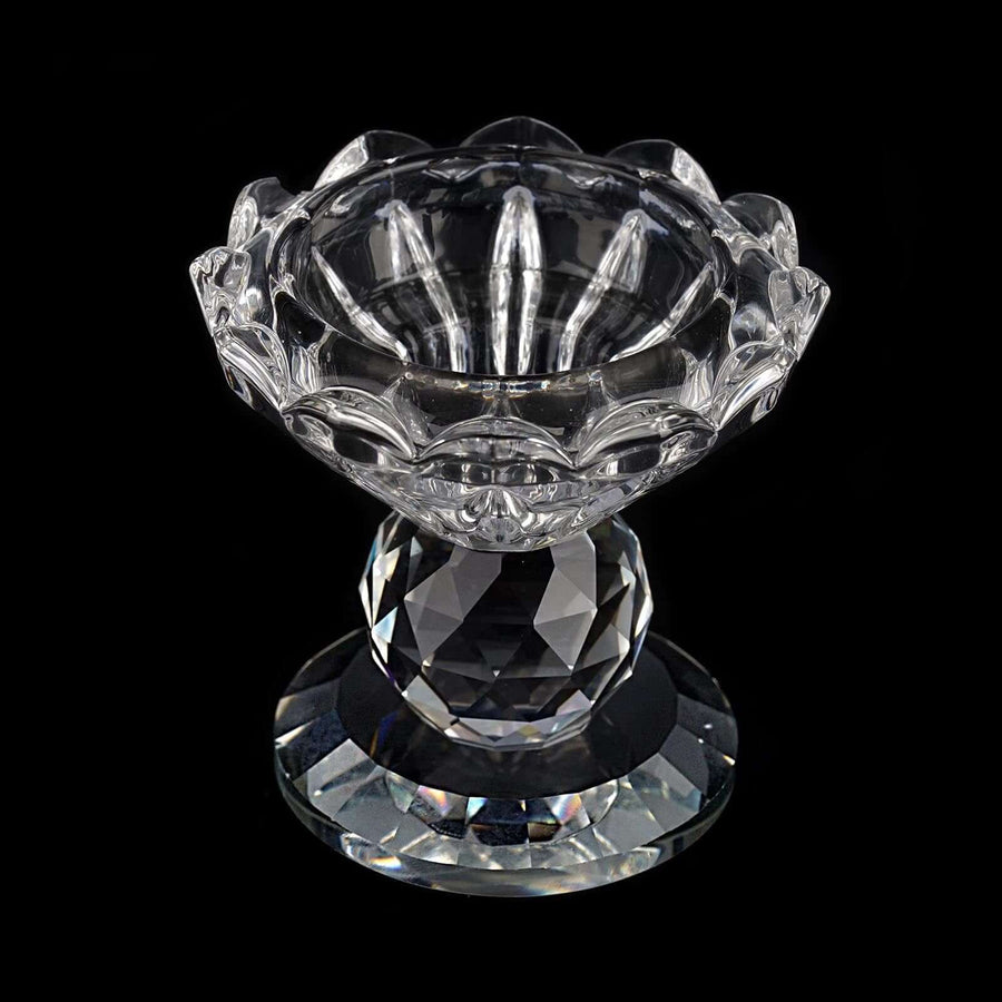 Crystal flower vase with diamond-cut design on a black background.