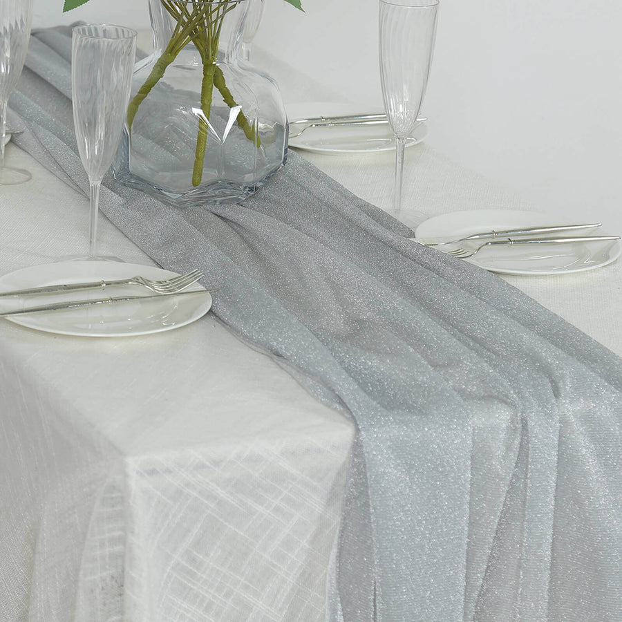 Elegant silver table runner on a white table setting with glassware.