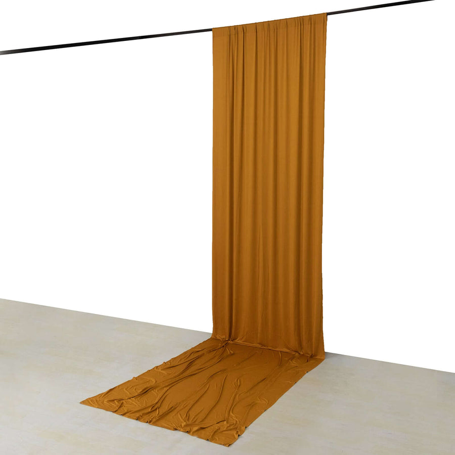 Mustard yellow fabric backdrop draped elegantly in studio setting