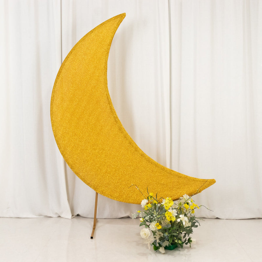 Gold glitter crescent moon decoration with flowers in front.