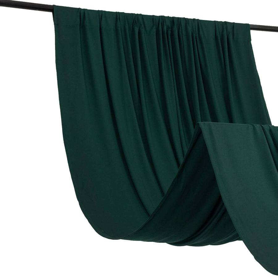 Dark green fabric draped elegantly on a black rod