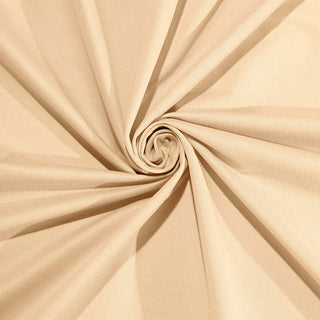 Beige textured fabric in a spiral pattern.