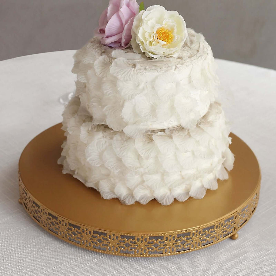 Elegant two-tier cake with floral decorations on a gold cake stand.