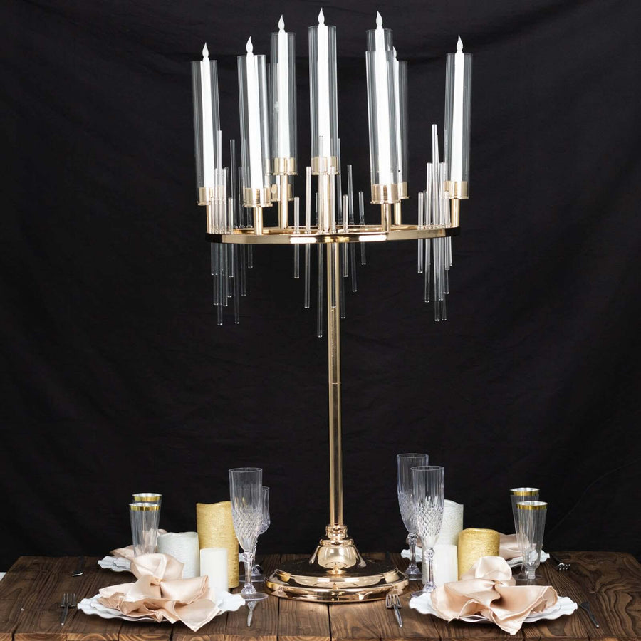 Elegant gold candelabra with tall glass candle holders on a rustic table setting.