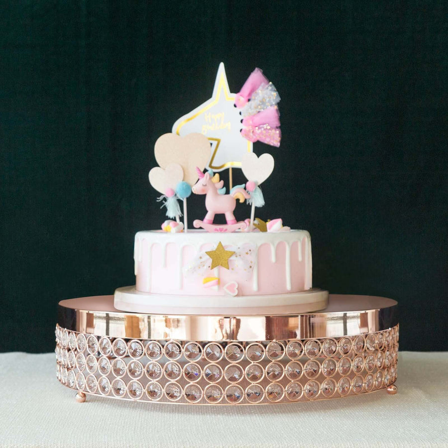 Unicorn-themed birthday cake decorated with stars and hearts, displayed on a decorative stand.