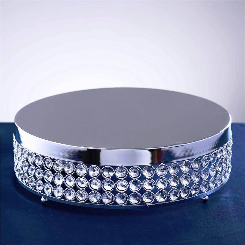 Silver display stand with rhinestone accents on a plain background.