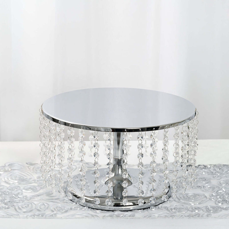 Round silver table with crystal accents on a reflective surface.