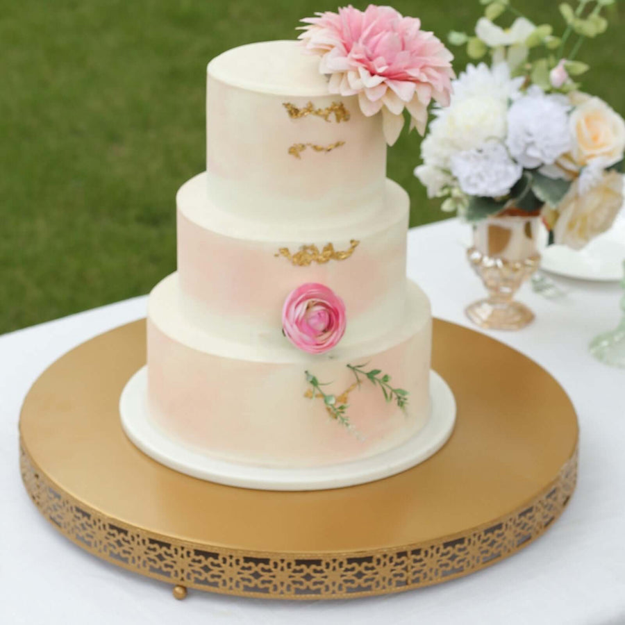 Elegant three-tiered wedding cake adorned with flowers and gold accents.