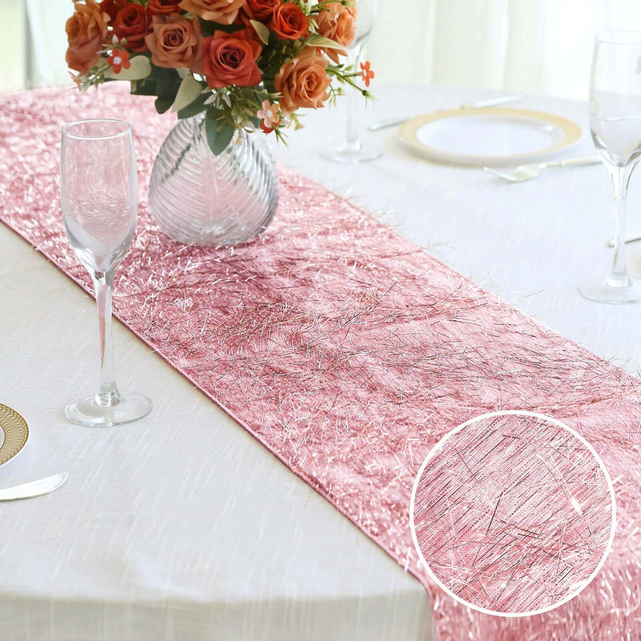 Pink table runner with silver accents on a dining table.