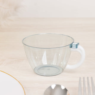 Clear plastic cup with a white handle, shown on a wooden surface.