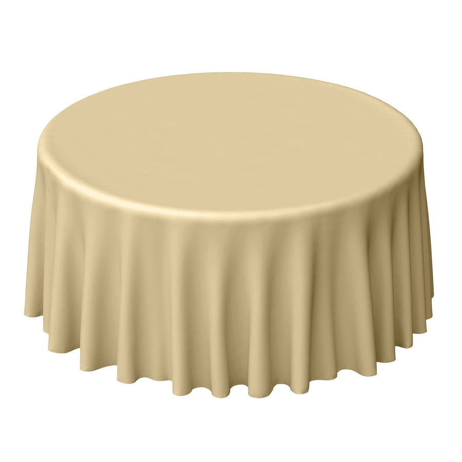 Round table with a beige tablecloth on a plain background