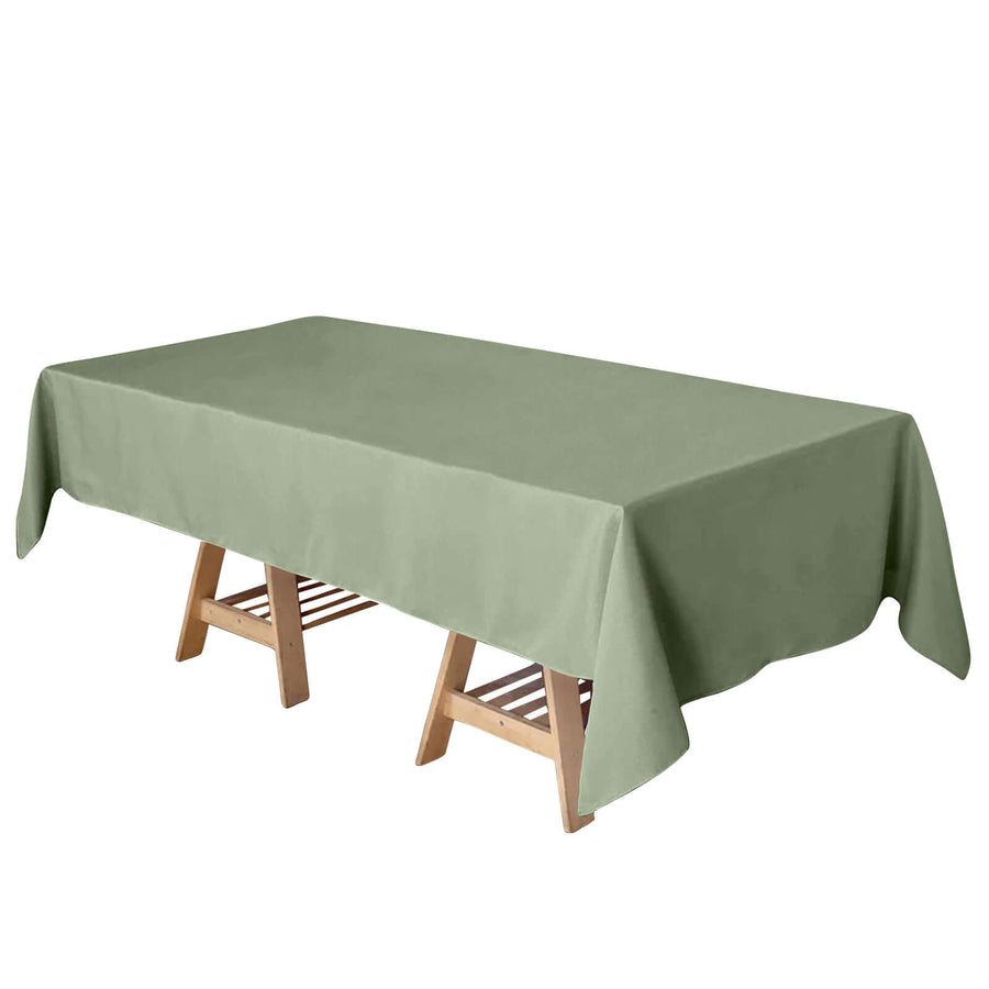 Green rectangular tablecloth draped over a wooden table