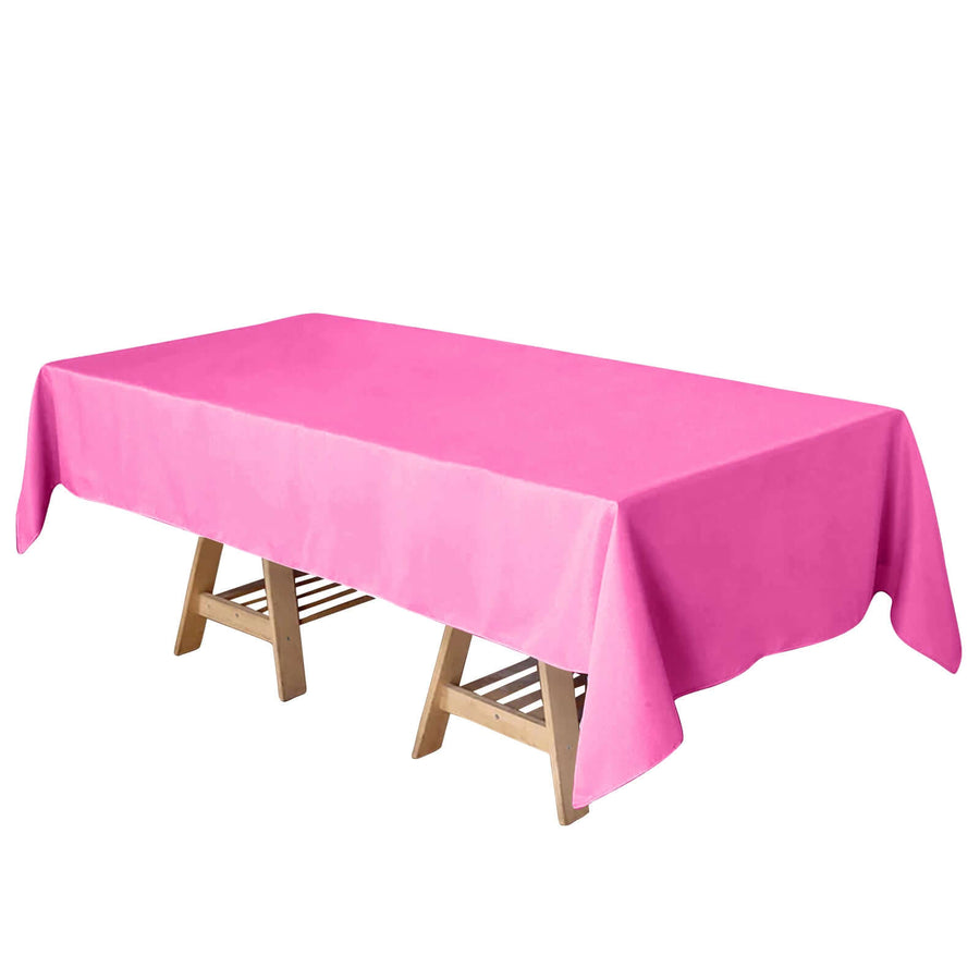 Pink tablecloth on a wooden table, perfect for parties and events.