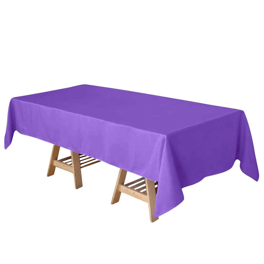 Purple tablecloth draped over a wooden table.