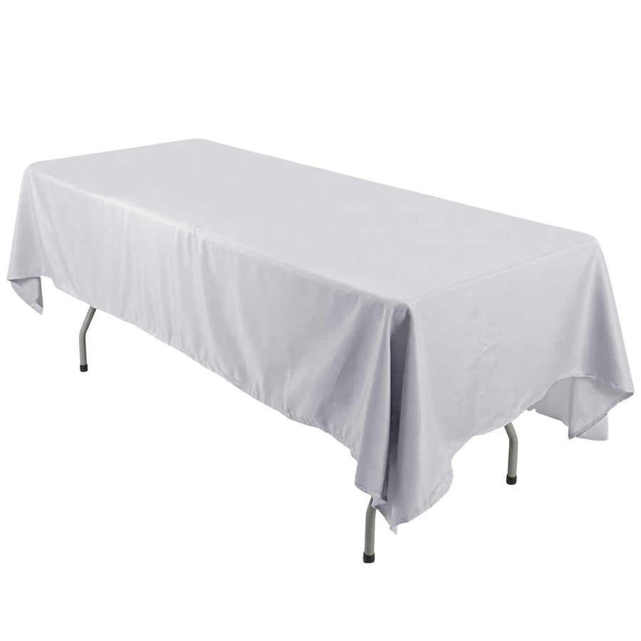 White tablecloth draped over a folding table in a studio setting.