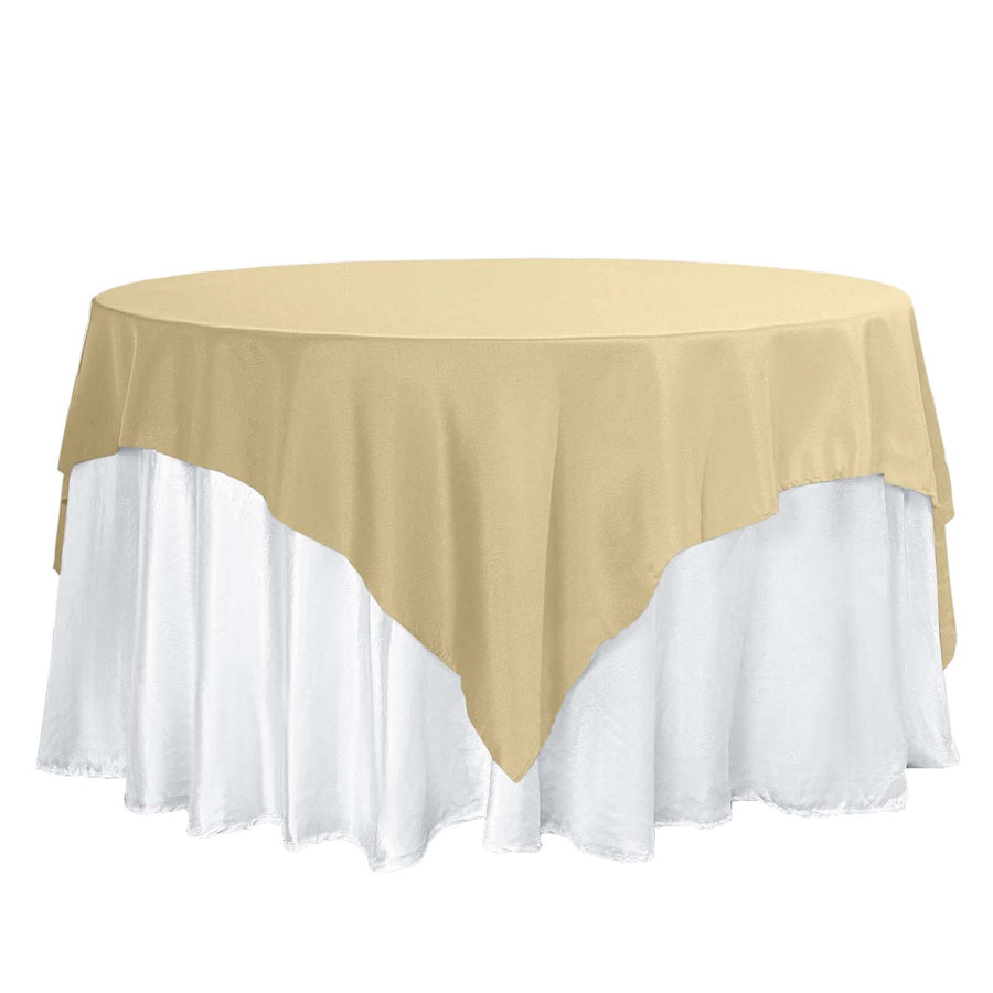 Gold and white tablecloth draped over a round table.
