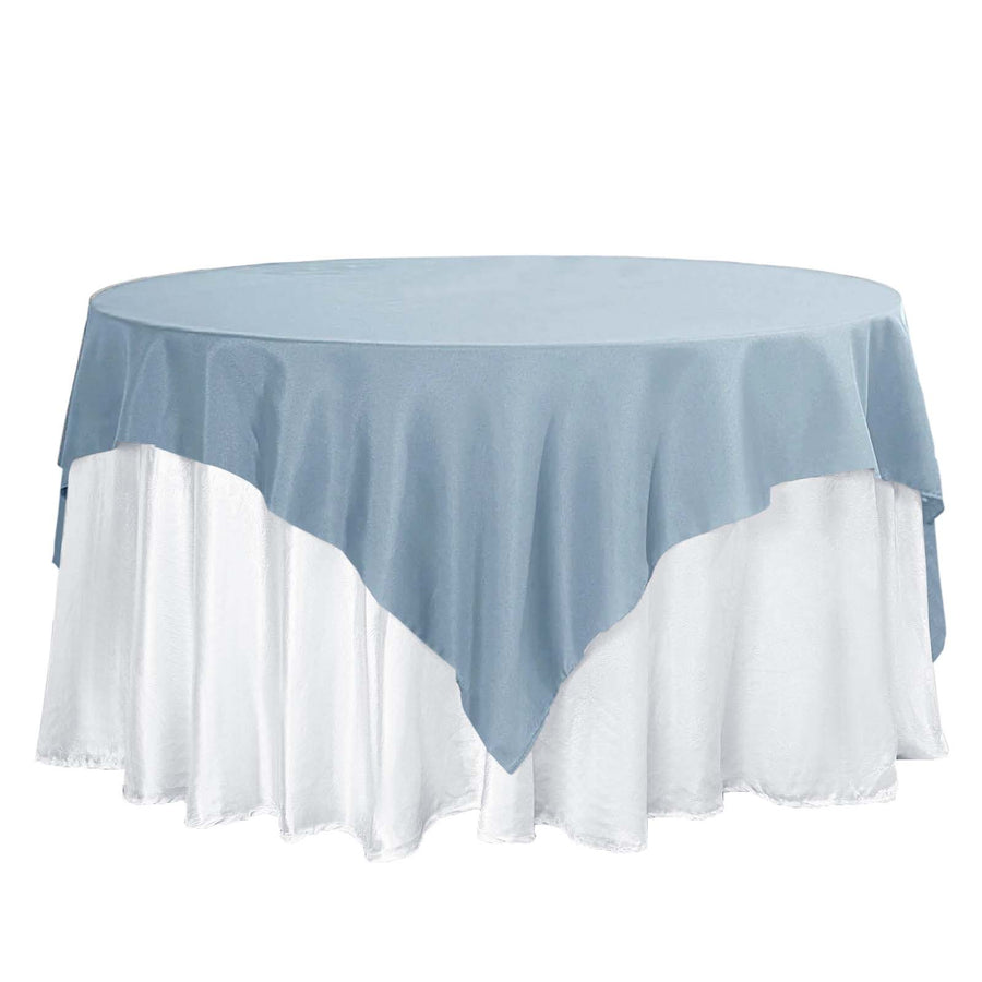 Round table with blue and white tablecloth layers