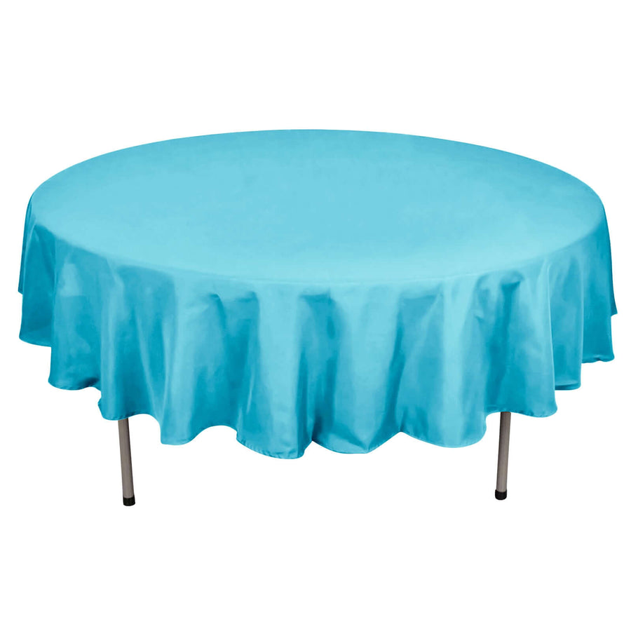 Round turquoise tablecloth with elegant draping.