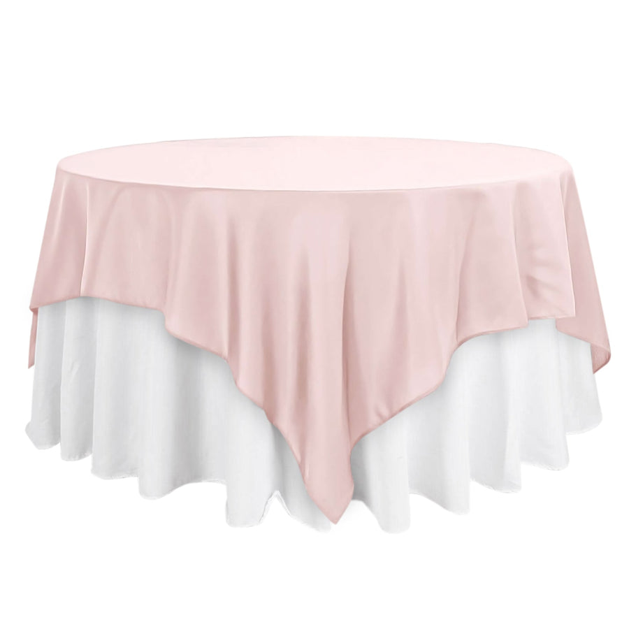 Pink and white round tablecloth set on a table.