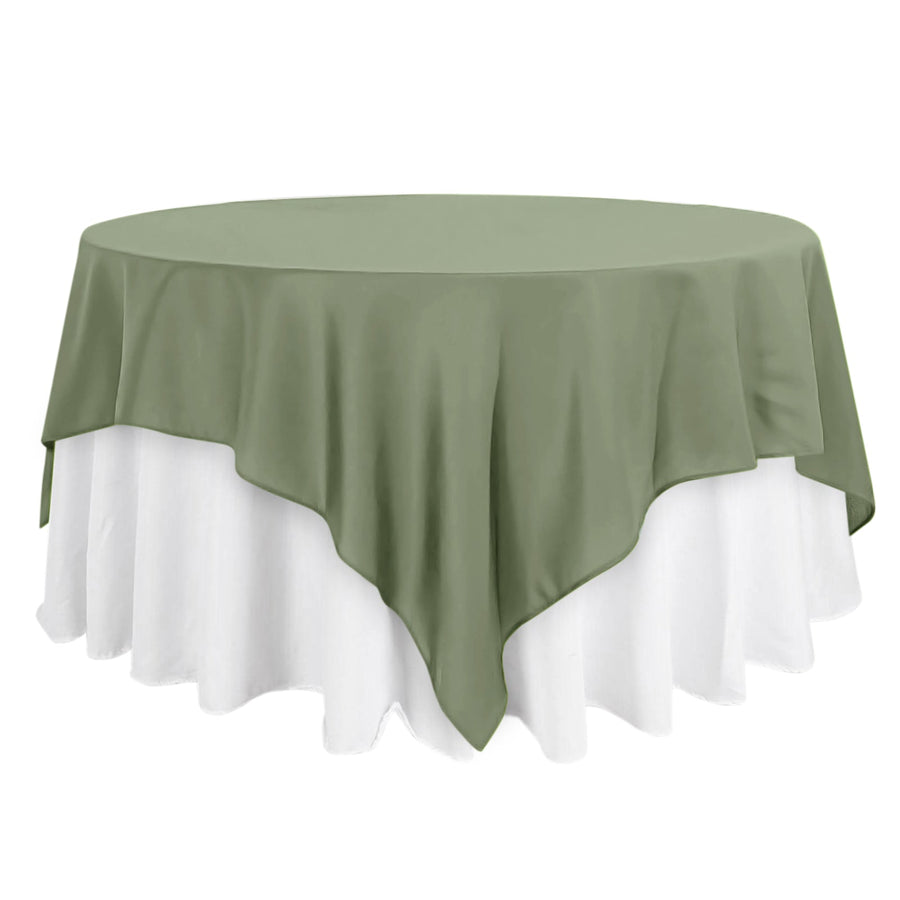 Round table with a green and white tablecloth.
