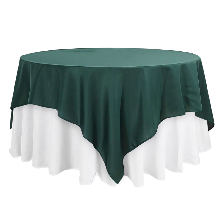 Green tablecloth draped elegantly over a round table