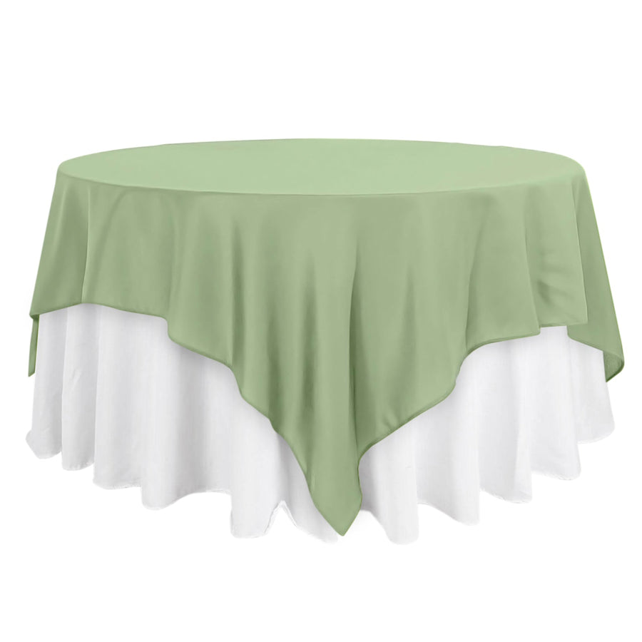 Green round tablecloth draped over a white table.