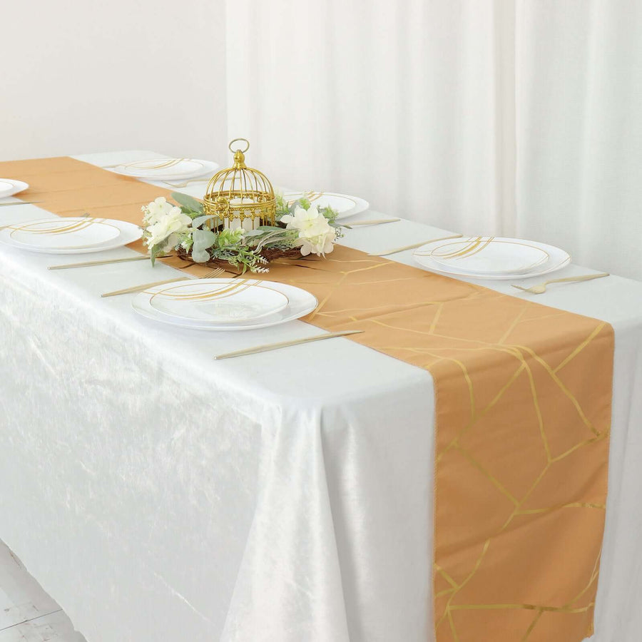 Elegant gold table runner on a white table setting with decorative elements.