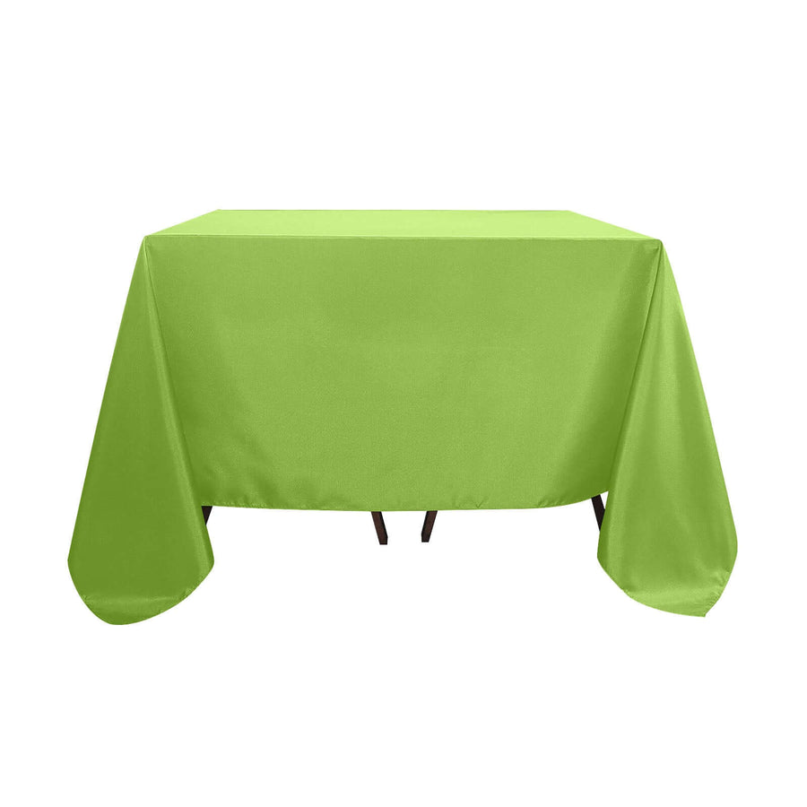 Green tablecloth draped over a table in a studio setting