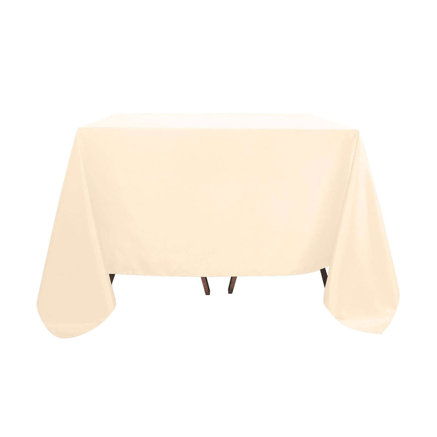 Beige tablecloth draped over a table, showcasing its smooth texture and full shape.
