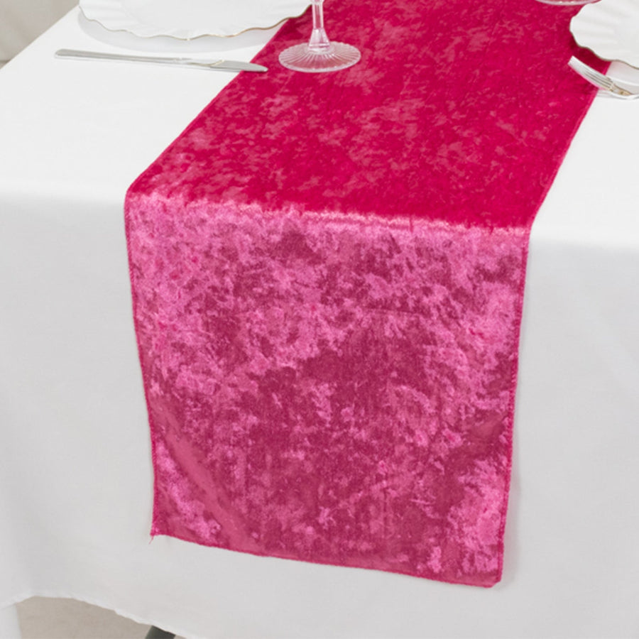 Pink velvet table runner on a white dining table setting.
