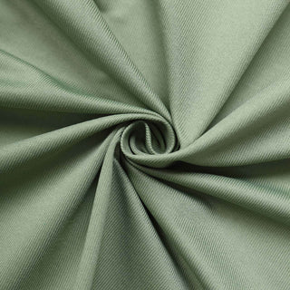 Green fabric texture in a spiral pattern.