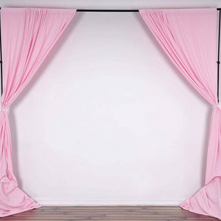 Pink backdrop curtains draped elegantly on a black frame.