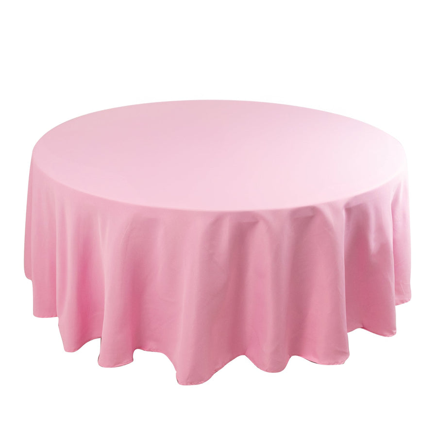 Round pink tablecloth with draped edge on a white background.