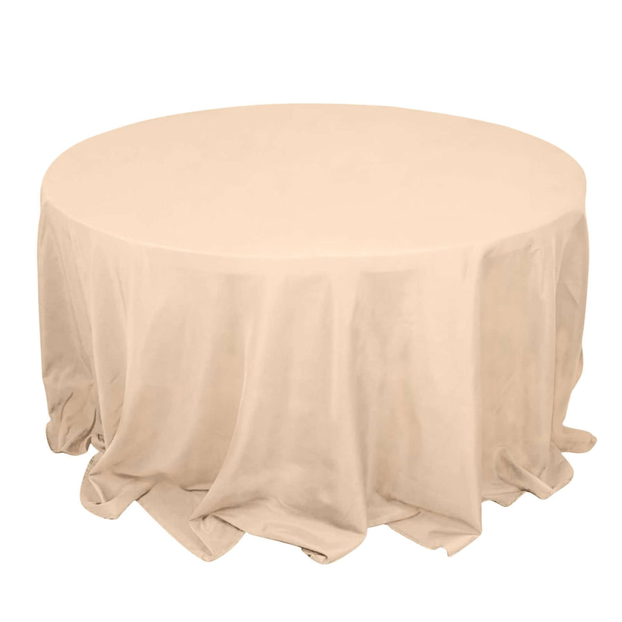 Round table covered with a beige tablecloth
