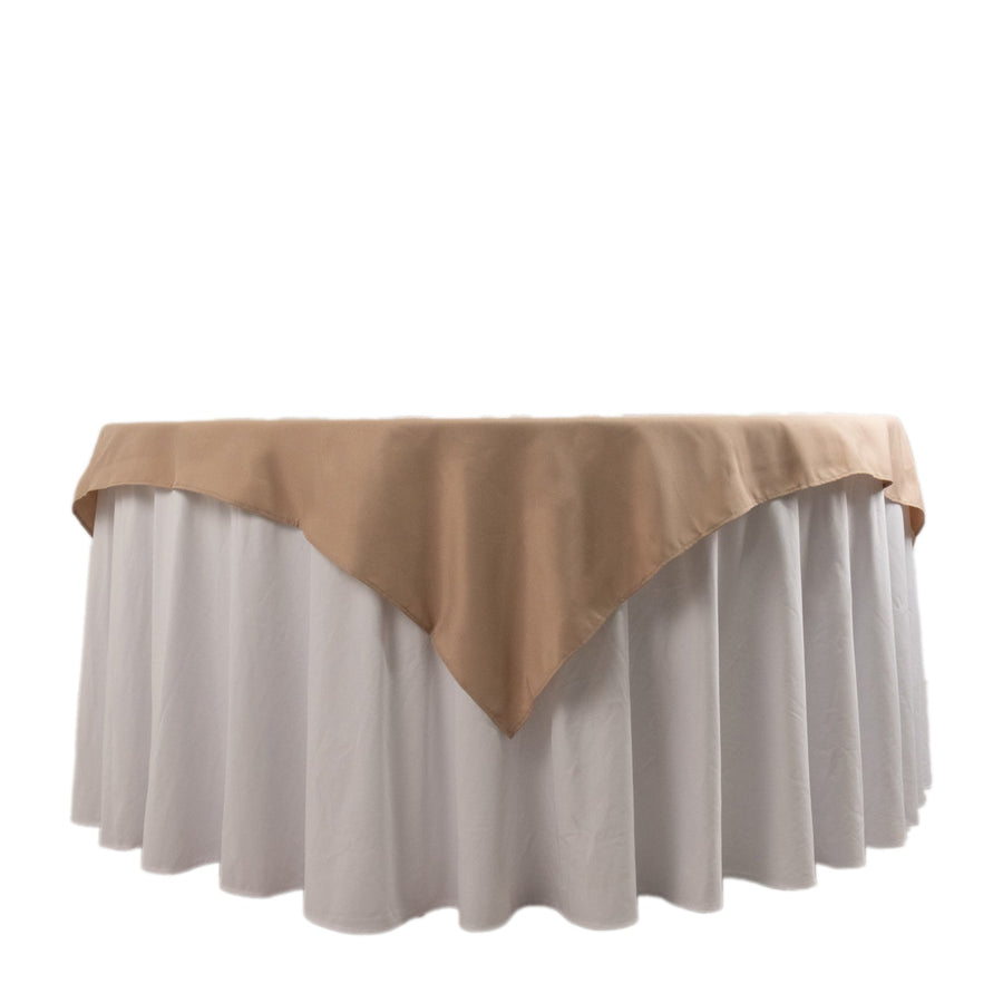 Round table with beige tablecloth and white skirting