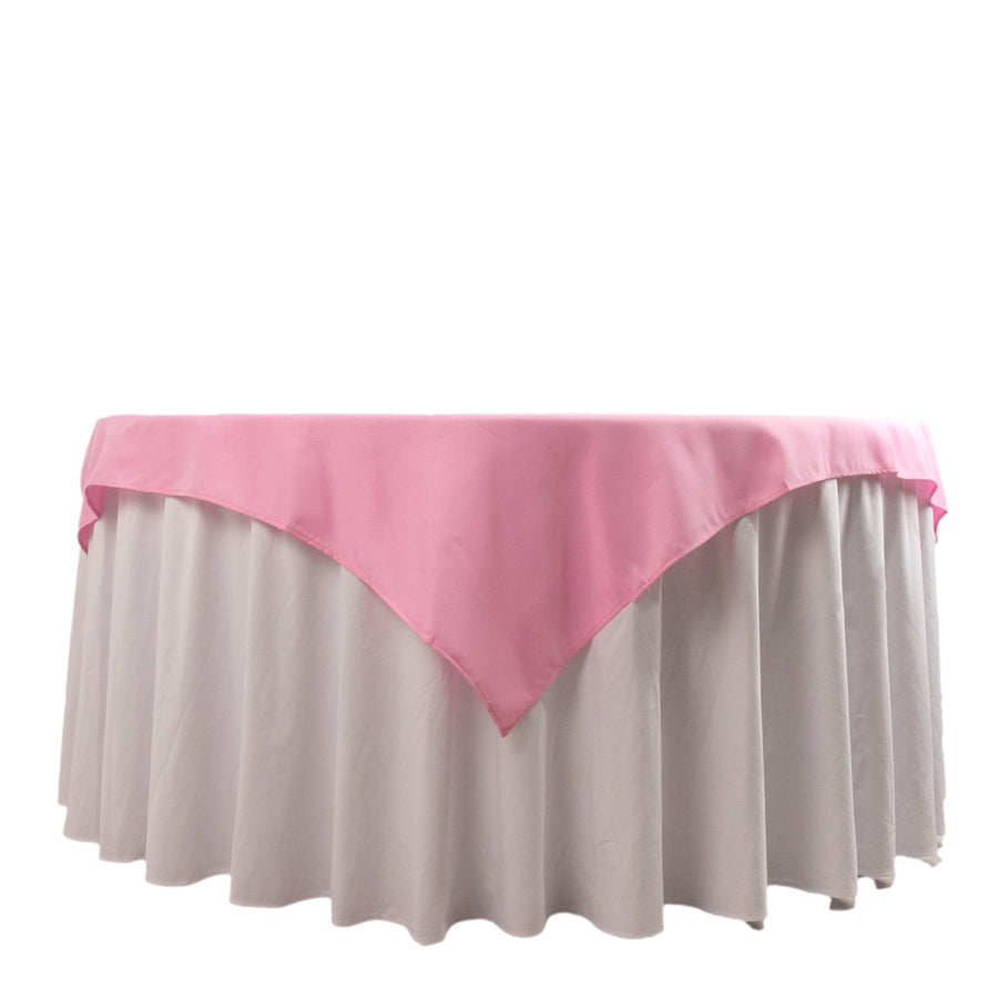 Pink table overlay on a white tablecloth, elegantly draped for events.