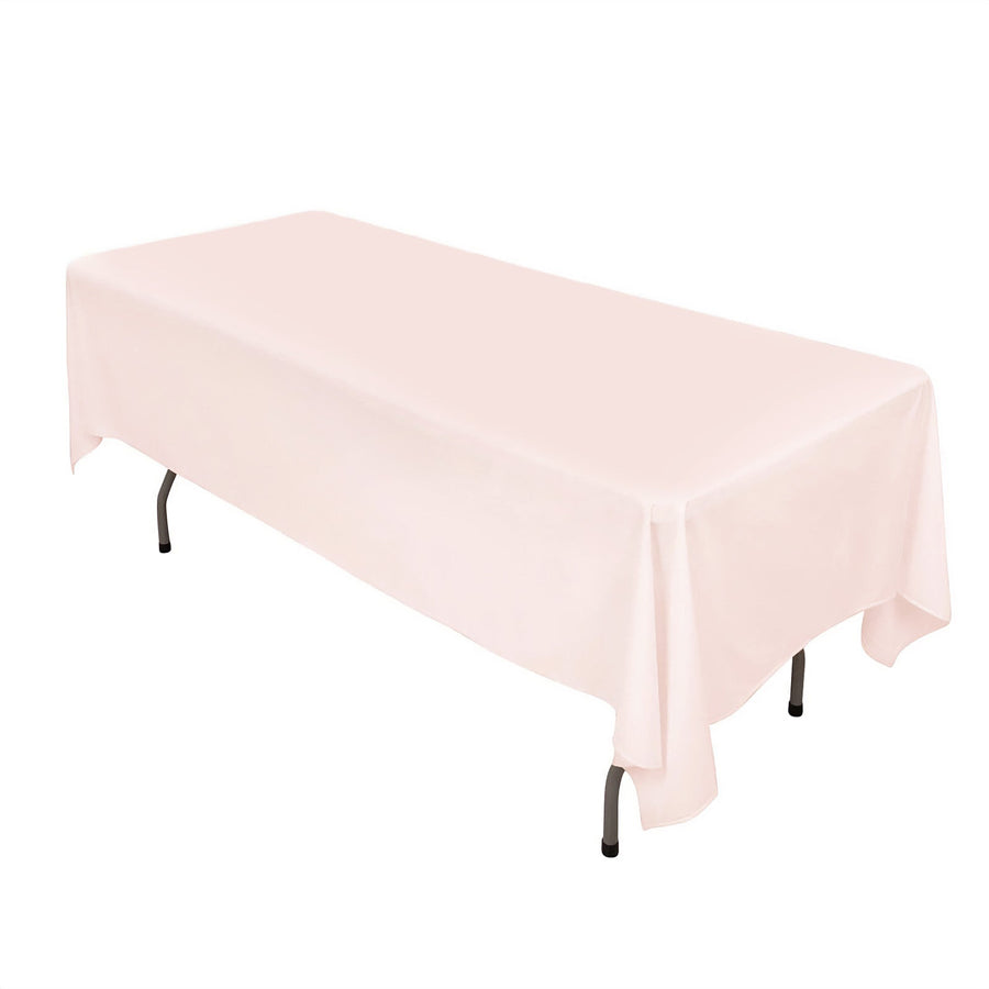 Pink tablecloth draped over a table on a plain background