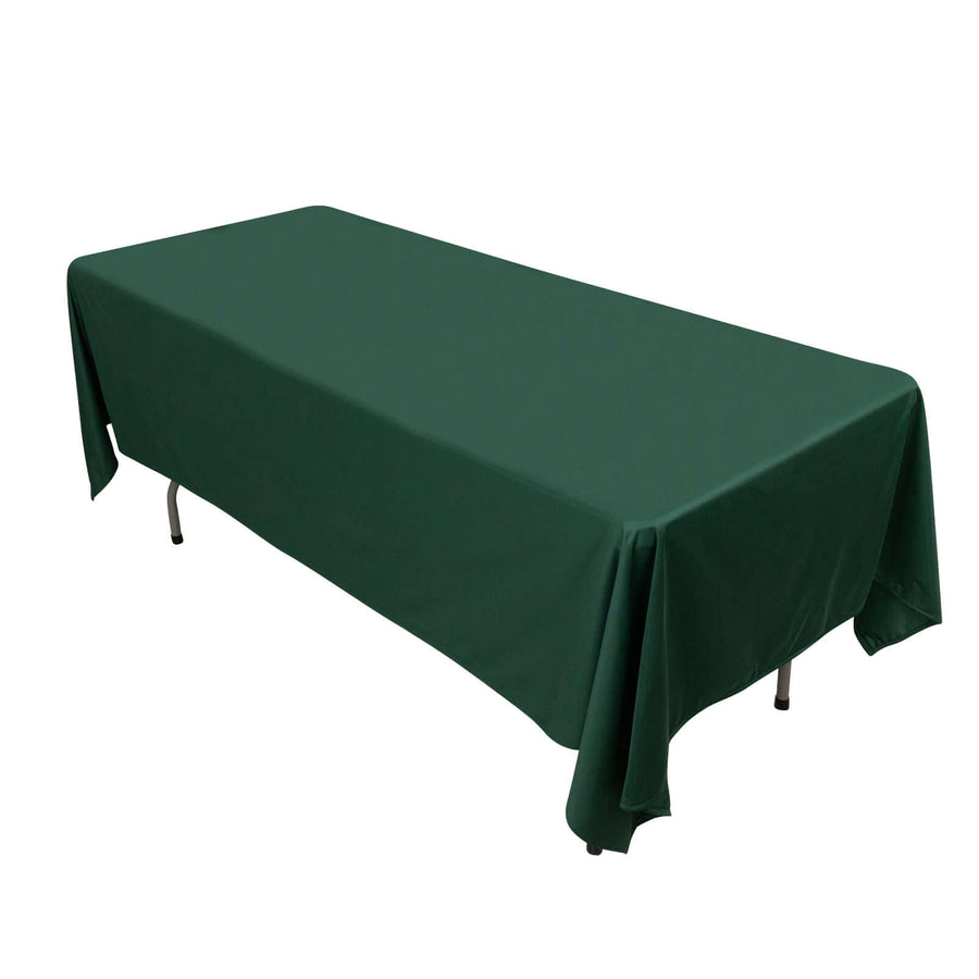 Green tablecloth draped over a rectangular table