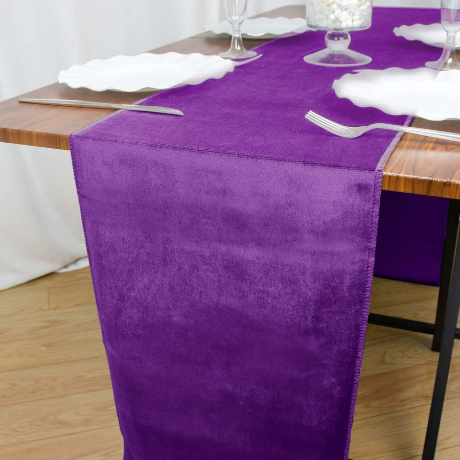 Purple velvet table runner on a wooden dining table setting.