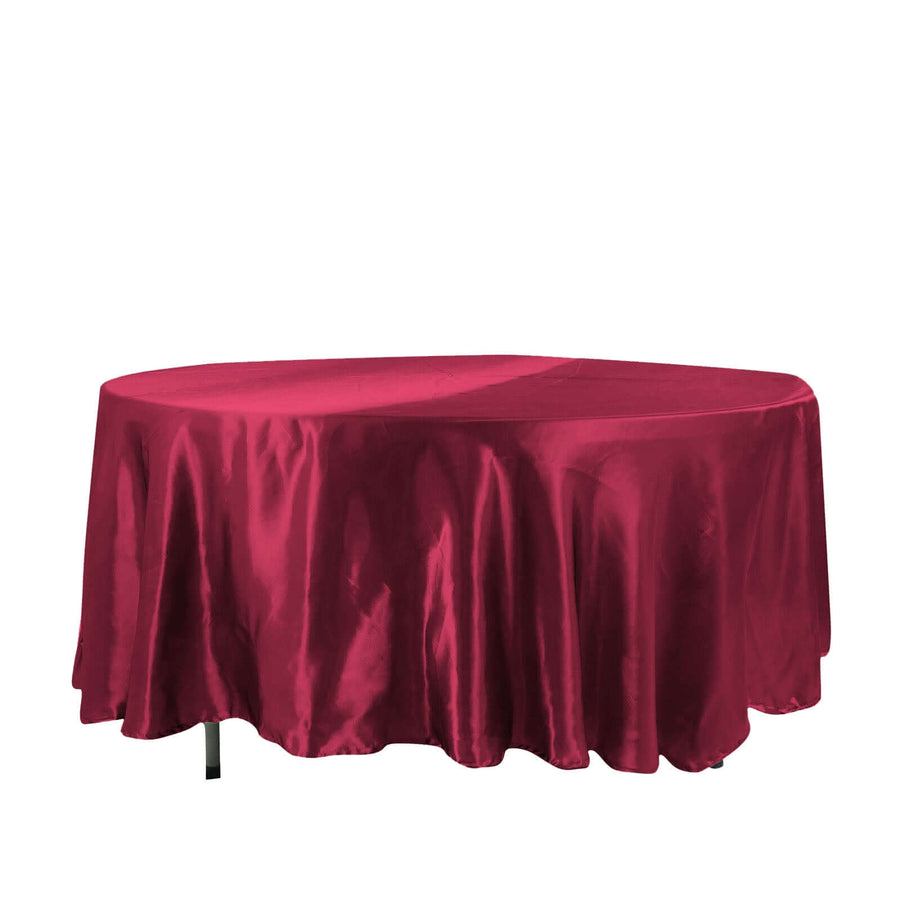 Red satin tablecloth draping over an oval table